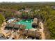 Aerial view of the community including pond, walking trails, tennis courts, and mature trees at 27 Lakes Edge Se Dr, Smyrna, GA 30080