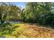 Fenced backyard, with an open space, and tennis court in background at 27 Lakes Edge Se Dr, Smyrna, GA 30080