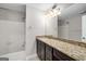Bathroom showcases granite countertops, a modern vanity, and a shower-tub combination at 27 Lakes Edge Se Dr, Smyrna, GA 30080