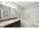 Bathroom offers a tub and shower combo, framed mirror, vanity, and granite countertop at 27 Lakes Edge Se Dr, Smyrna, GA 30080
