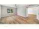 Bright bedroom features hardwood floors, modern ceiling fan, and large window with lovely pond view at 27 Lakes Edge Se Dr, Smyrna, GA 30080