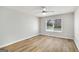 Bright bedroom with light wood-colored flooring and a window provides ample natural light at 27 Lakes Edge Se Dr, Smyrna, GA 30080