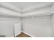 Walk-in closet with neutral paint and shelving is ready for easy organization at 27 Lakes Edge Se Dr, Smyrna, GA 30080