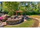 Retreat to this lovely outdoor entertainment space with pergola, flowering plants, and seating at 27 Lakes Edge Se Dr, Smyrna, GA 30080