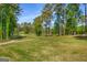 Scenic view of a golf course fairway with lush greenery and tall pine trees at 27 Lakes Edge Se Dr, Smyrna, GA 30080