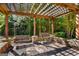 Pergola offers bench swings and shade to relax in style, overlooking the property gardens at 27 Lakes Edge Se Dr, Smyrna, GA 30080