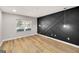 An empty room with an accent wall with a window and light wood-colored flooring provides ample natural light at 27 Lakes Edge Se Dr, Smyrna, GA 30080