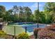 Outdoor tennis court with green and blue surface, enclosed by a fence at 27 Lakes Edge Se Dr, Smyrna, GA 30080