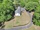 Aerial perspective of the property displaying a home, a sprawling yard, a pond, and winding driveway at 701 Mask Rd, Brooks, GA 30205