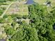 Aerial view showing the property's 3.26 acres of land, pond, house, and wooded surroundings at 701 Mask Rd, Brooks, GA 30205