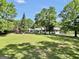 Expansive backyard featuring a lush lawn and mature trees, providing a private setting at 701 Mask Rd, Brooks, GA 30205