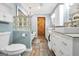Stylish bathroom features tiled floors, double vanity sinks, bathtub, and a wooden barn door at 701 Mask Rd, Brooks, GA 30205