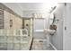 Bathroom with a tub-shower featuring a glass block partition and a white pedestal sink at 701 Mask Rd, Brooks, GA 30205