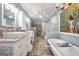 A spacious bathroom featuring double sinks, a standalone tub, glass block accents, and stylish fixtures at 701 Mask Rd, Brooks, GA 30205