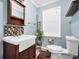 Cozy bathroom with a farmhouse sink, vintage mirror, and stylish tile accents at 701 Mask Rd, Brooks, GA 30205