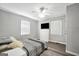 Cozy bedroom features a ceiling fan, dresser, windows, and wood flooring for a comfortable space at 701 Mask Rd, Brooks, GA 30205