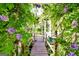Picturesque garden path adorned with vibrant purple wisteria and lush greenery at 701 Mask Rd, Brooks, GA 30205