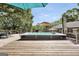 Outdoor hot tub situated on a wooden deck, offering a relaxing oasis with landscaped surroundings at 701 Mask Rd, Brooks, GA 30205