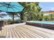 Relaxing hot tub with umbrellas on a spacious wooden deck, surrounded by trees and tranquil views at 701 Mask Rd, Brooks, GA 30205