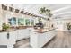 Bright and airy kitchen featuring white cabinetry, a large island, granite countertops and stone accents at 701 Mask Rd, Brooks, GA 30205