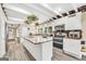A spacious kitchen with white cabinets, a large island, stainless steel appliances and lots of storage space at 701 Mask Rd, Brooks, GA 30205