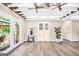 Bright and airy living room with vinyl floors, french doors and a sewing machine repurposed as a table at 701 Mask Rd, Brooks, GA 30205