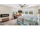 Bright main bedroom featuring a fireplace, ceiling fan, and large windows at 701 Mask Rd, Brooks, GA 30205