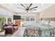 Bright main bedroom featuring large windows, ceiling fan, and wood-look flooring at 701 Mask Rd, Brooks, GA 30205