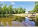 Scenic view of a pond reflecting a gazebo, creating a peaceful setting amidst lush greenery at 701 Mask Rd, Brooks, GA 30205