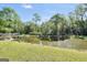Scenic pond view featuring a charming gazebo and lush green surroundings under a bright blue sky at 701 Mask Rd, Brooks, GA 30205