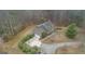 Aerial view of a house showcasing its landscaping, driveway, and surrounding wooded area at 4186 Highway 138 Sw, Stockbridge, GA 30281