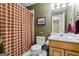 Bathroom featuring a shower with a plaid curtain and a toilet at 4186 Highway 138 Sw, Stockbridge, GA 30281