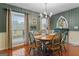 Traditional dining room featuring green and white checkered wallpaper and wood floors at 4186 Highway 138 Sw, Stockbridge, GA 30281
