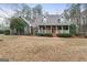 Charming two-story home with a welcoming front porch and mature landscaping at 4186 Highway 138 Sw, Stockbridge, GA 30281