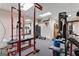 Fully equipped home gym featuring weightlifting equipment, punching bag, and a mirrored wall at 4186 Highway 138 Sw, Stockbridge, GA 30281