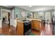 Open kitchen with stainless steel oven, wood cabinets, and adjacent breakfast nook at 4186 Highway 138 Sw, Stockbridge, GA 30281