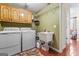 Functional laundry room featuring tile floors, sink, washer, dryer, and storage at 4186 Highway 138 Sw, Stockbridge, GA 30281