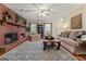 A comfortable living room with a brick fireplace, hardwood floors, and cozy decor at 4186 Highway 138 Sw, Stockbridge, GA 30281
