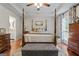 Beautifully decorated main bedroom with hardwood floors, tray ceiling, and stylish furnishings at 4186 Highway 138 Sw, Stockbridge, GA 30281