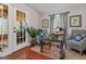 Inviting sitting room with brick floors, stylish decor, cozy seating, and French doors at 4186 Highway 138 Sw, Stockbridge, GA 30281
