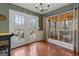 Charming sunroom with access to deck, natural light, and checkered wallpaper accent wall at 4186 Highway 138 Sw, Stockbridge, GA 30281