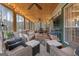 Cozy screened-in porch with ample seating, string lights, wooded views, and 'Sweet Tea' sign at 4186 Highway 138 Sw, Stockbridge, GA 30281