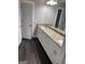 Modern bathroom features a long vanity with double sinks, granite countertops, and a large mirror at 606 Gardner Rd, Stockbridge, GA 30281
