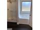 Bathroom featuring a glass-enclosed shower and a separate bathtub with a window at 606 Gardner Rd, Stockbridge, GA 30281