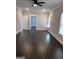 Spacious bedroom features hardwood floors, modern ceiling fan, and neutral paint at 606 Gardner Rd, Stockbridge, GA 30281