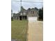 Charming two-story brick home with a well-manicured lawn and attached two-car garage at 606 Gardner Rd, Stockbridge, GA 30281