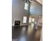 Spacious living room with a fireplace, high ceilings, and beautiful hardwood floors at 606 Gardner Rd, Stockbridge, GA 30281