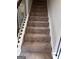 Carpeted staircase with decorative balusters leads to the next level in this stylish and modern home at 606 Gardner Rd, Stockbridge, GA 30281