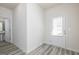 Bright entryway with light wood-look flooring and a white front door with window at 431 Prescott Way, Villa Rica, GA 30180