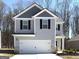 Charming two-story home with a gray exterior, white trim, black shutters, and a two-car garage at 431 Prescott Way, Villa Rica, GA 30180